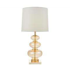 La lampada da tavolo o comodino BRISTON con paralume bianco un mix di tre materiali vetro dorato, metallo e tessuto ignifugo.