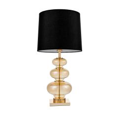 La lampada da tavolo o comodino BRISTON con paralume nero un mix di tre materiali vetro dorato, metallo e tessuto ignifugo.