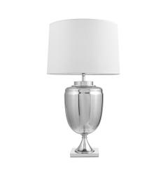 La lampada da tavolo o comodino OLIMPIA con paralume bianco un mix di tre materiali vetro argentato, metallo e tessuto ignifugo.